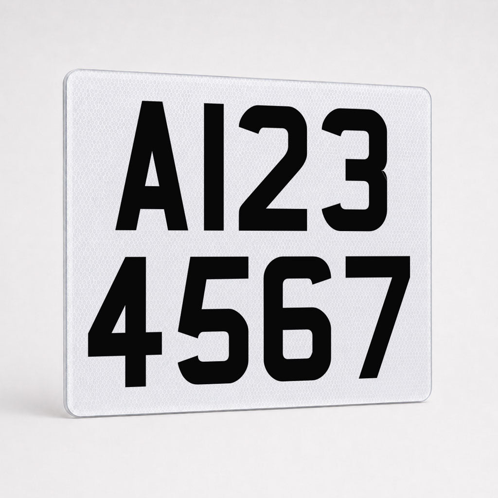 White reflective two-line trailer registration plate with A123 over 4567